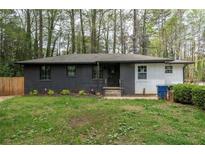 Cozy one-story home with a dark painted brick facade and front lawn at 2191 Camp Ground Rd, Atlanta, GA 30331