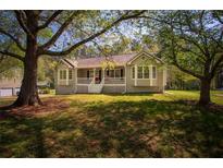 Charming single-story home featuring a welcoming front porch with white railings, and a well-maintained lawn at 670 Maplelake Dr, Acworth, GA 30101