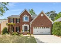 Charming two-story brick home with well-manicured lawn and attached two-car garage at 4223 Millside Se Walk, Smyrna, GA 30080