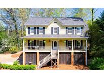 Charming two-story home featuring a welcoming front porch and well-maintained landscaping at 4520 Windsor Oaks Dr, Marietta, GA 30066