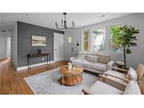 Bright living room with hardwood floors, modern lighting, and stylish decor at 912 Fairburn Nw Rd, Atlanta, GA 30331