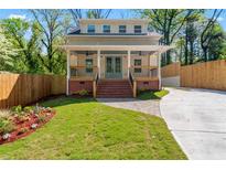 Charming two-story home with a well-maintained front yard and inviting brick steps leading to the covered porch at 195 Childs Nw Dr, Atlanta, GA 30314