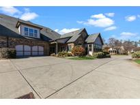 Charming home with a two-car garage, beautiful brickwork, and well-manicured landscaping at 120 Chastain Nw Rd # 608, Kennesaw, GA 30144