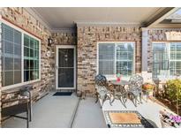 Cozy brick porch with charming seating and ample natural light, perfect for relaxation at 120 Chastain Nw Rd # 608, Kennesaw, GA 30144