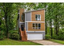 Modern two-story home with a contemporary design and wooded lot at 2465 Rockcliff Se Rd, Atlanta, GA 30316
