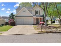 Charming two-story home with a two-car garage and well-maintained landscaping in a suburban neighborhood at 4070 Amber Leaf Dr, Roswell, GA 30076