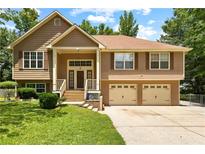 Inviting two-story home with a well-manicured lawn and a two-car garage, perfect for suburban living at 9283 Whaleys Lake Ln, Jonesboro, GA 30238
