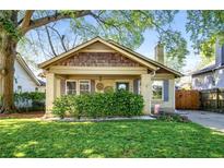 Charming bungalow featuring a well-manicured lawn, inviting front porch, and unique architectural details at 1450 Oglethorpe Sw Ave, Atlanta, GA 30310