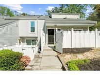 Charming townhouse with a white picket fence and well-maintained landscaping at 2693 Greentree Se Dr, Marietta, GA 30067