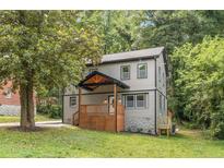 Charming two-story home with wooden porch and well-maintained front yard at 1857 Glendale Dr, Decatur, GA 30032