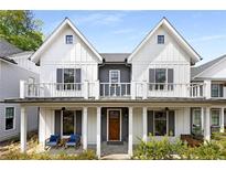 Charming two-story home with a covered front porch and balcony, offering inviting curb appeal at 1911 Commons Cir, Brookhaven, GA 30341