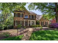 Charming two-story brick home featuring manicured landscaping and a welcoming front porch at 131 Helmswood Sw Cir, Marietta, GA 30064