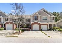 Charming townhome with a brick front, attached garage, and a well-maintained lawn at 168 Ellis Dr, Conyers, GA 30012