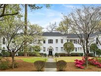 Beautiful multi-Gathering home featuring manicured landscaping and symmetrical design elements at 21 Peachtree Memorial Nw Dr # 12, Atlanta, GA 30309