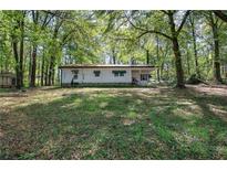 Quaint single story home featuring green awnings and a wooded yard at 92 Valley Se Trl, Acworth, GA 30101