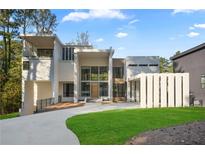 Stunning modern home with a manicured lawn, porte-cochere, and grand entrance at 2650 Fairoaks Rd, Decatur, GA 30033
