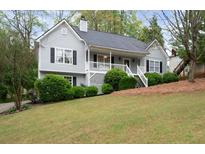 Charming home featuring a well-maintained lawn and a classic porch at 350 Spring View Ct, Dallas, GA 30157