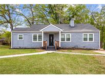 Charming one-story home with gray brick exterior, a manicured lawn, and a inviting entrance with stairs at 1623 Athens Sw Ave, Atlanta, GA 30310