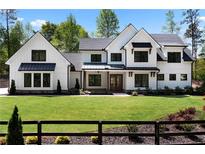 Beautiful two-story home featuring black frame windows and a meticulously manicured front lawn at 120 Farm Gate Dr, Woodstock, GA 30188