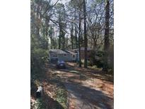 Cozy single-story home with brick accents and a private, tree-lined driveway at 2485 Ortega N Way, Chamblee, GA 30341