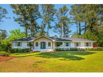 Charming, single-story home features a well-manicured lawn, classic brick exterior, and mature trees at 3365 Ardley Sw Rd, Atlanta, GA 30311