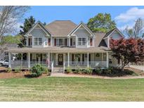 Charming two-story home with a welcoming front porch, manicured lawn, and lovely curb appeal at 60 Bartlett Way, Dallas, GA 30157