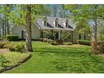 Charming home with lush front yard, mature trees and beautiful landscaping at 770 Raleigh Sw Ct, Marietta, GA 30064