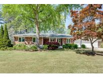 Charming brick home with well-manicured lawn and mature trees offering great curb appeal at 1802 N Akin Ne Dr, Atlanta, GA 30345