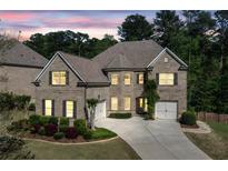 Charming brick home featuring manicured landscaping, attached two-car garage, and a well-maintained lawn at 2564 Walden Estates Dr, Marietta, GA 30062