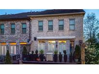 Charming rear exterior features a cozy balcony and manicured landscaping, offering a serene outdoor living space at 3663 Brookhaven Manor Ne Xing, Atlanta, GA 30319