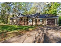Charming single-story home with a inviting front porch and an attached garage at 1441 Cahaba Sw Dr, Atlanta, GA 30311