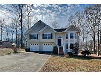 Charming two-story home featuring an attached two-car garage and a well-maintained front yard at 1550 Royale Castle Dr, Lawrenceville, GA 30043