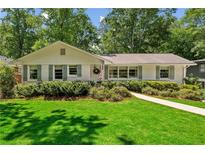 Charming single story home with a well-maintained front lawn and mature landscaping at 389 Valley Brook Ne Dr, Atlanta, GA 30342