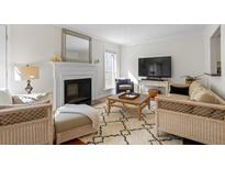 Cozy living room with fireplace, plush seating, and a stylish woven coffee table at 3689 Essex Ave # 16, Atlanta, GA 30339