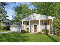 Charming two-story home featuring a well-maintained lawn and lovely landscaping at 2202 Green Forrest Dr, Decatur, GA 30032