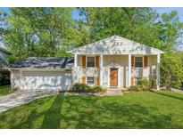 Charming traditional home with a well-manicured lawn, brick facade, and inviting front entrance at 2202 Green Forrest Dr, Decatur, GA 30032