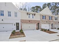 View of new townhome exteriors, showing multi-tone brick and painted siding at 1616 Ruskin Way, Marietta, GA 30062