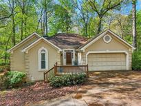 Attractive single-Gathering home with a well-manicured front yard and charming front porch at 230 Oakmere Dr, Alpharetta, GA 30009