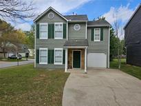 Charming two-story home featuring green shutters, a one-car garage, and a well-manicured front lawn at 6718 Roscommon Dr, Austell, GA 30168