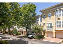 Townhome exterior with garages, landscaping, and brick accents at 375 Highland Ne Ave # 508, Atlanta, GA 30312