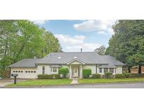 Charming single-story home featuring a well-maintained lawn, a two-car garage, and a welcoming front entrance at 2988 Chipmunk Se Trl, Marietta, GA 30067