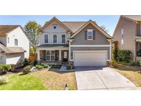 Charming two-story home with a well-manicured lawn and an attached two-car garage at 625 Lorimore Pass, Canton, GA 30115