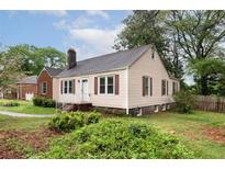 Charming home featuring light siding, dark shutters, and a well-maintained front yard at , Tucker, GA 30084