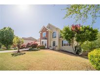Charming two-story home featuring a well-manicured lawn and beautiful landscaping at 1356 Belfaire Trce, Dacula, GA 30019