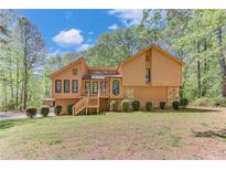 Charming two-story home with wood facade, stone accents, and professionally landscaped front yard at 1552 Sever Rd, Lawrenceville, GA 30043
