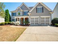 Charming two-story home with a well-manicured front yard and attached two-car garage at 5177 Cabot Creek Dr, Buford, GA 30518