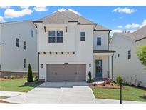 Charming two-story home with a gray two car garage and a landscaped front yard at 627 Skytop Dr, Cumming, GA 30040
