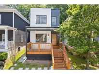 Modern two-story home features a mixed facade, wooden deck, and landscaped front yard at 906 Mcdaniel St, Atlanta, GA 30310