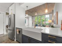 Modern kitchen featuring stainless steel appliances, granite countertops, and a view of the living area at 245 N N Highland Ne Ave # 220, Atlanta, GA 30307