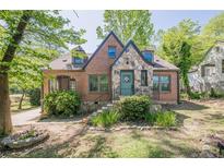 Charming brick home with stone accents, well-maintained lawn, and inviting curb appeal at 1884 Montrose Dr, East Point, GA 30344